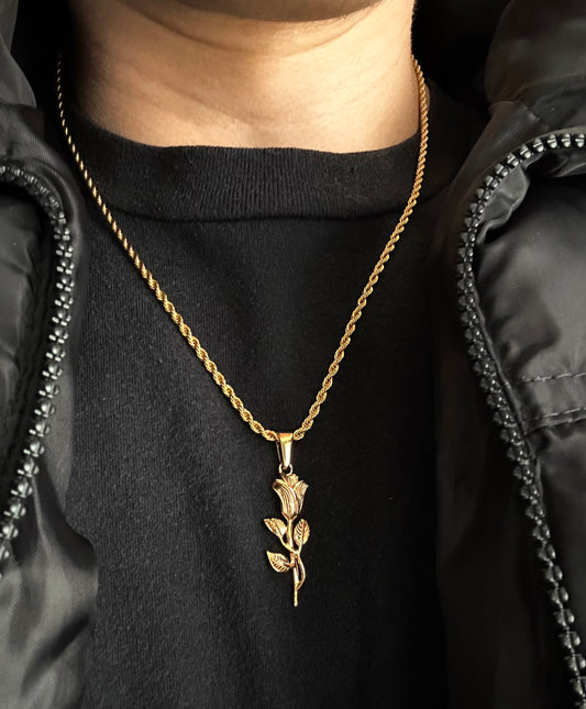 dude wearing a gold rope chain with a rose pendant on it 